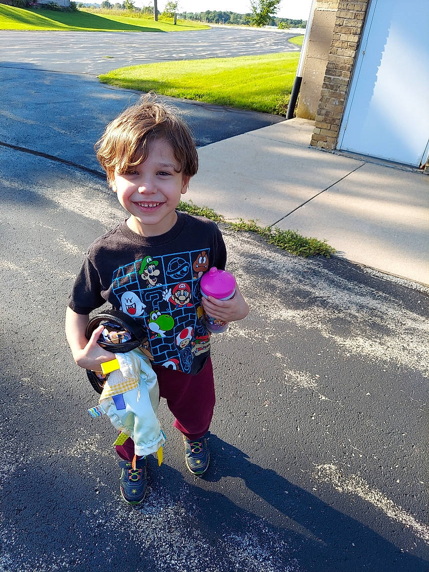 Sebastian is registered to the contest to win money with this photo: asphalt, cool, electric_blue, fun, grass, happy, head, joy, leisure, people_in_nature, person, plant, recreation, road, road_surface, sidewalk, smile, standing, summer, t_shirt