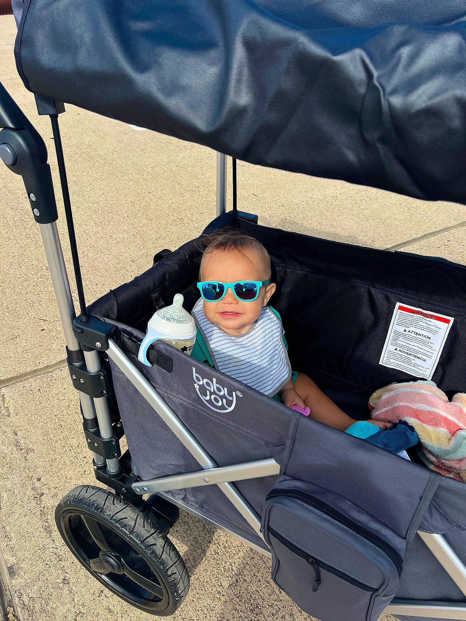 Omari joined the competition — help win amazing prizes! auto_part, automotive_design, baby, baby_carriage, baby_toddler_clothing, car_seat, comfort, electric_blue, eyewear, goggles, lap, person, product, sitting, sunglasses, tints_and_shades, tire, toddler, vision_care, wheel
