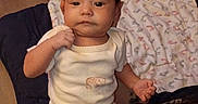 Avayah is registered to the contest to win money with this photo: baby, infant, child, person, onesie, clothing, hand, face, hair, floor, blanket, pattern, furniture, indoor, human, skin, cute, holding, young, expression