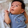baby, infant, blue_clothing, spiky_hair, looking_up, cute, adorable, soft_blanket, indoor, portrait, child, newborn, expression, skin, face, hand, laying_down, young_child, cozy, sleepwear