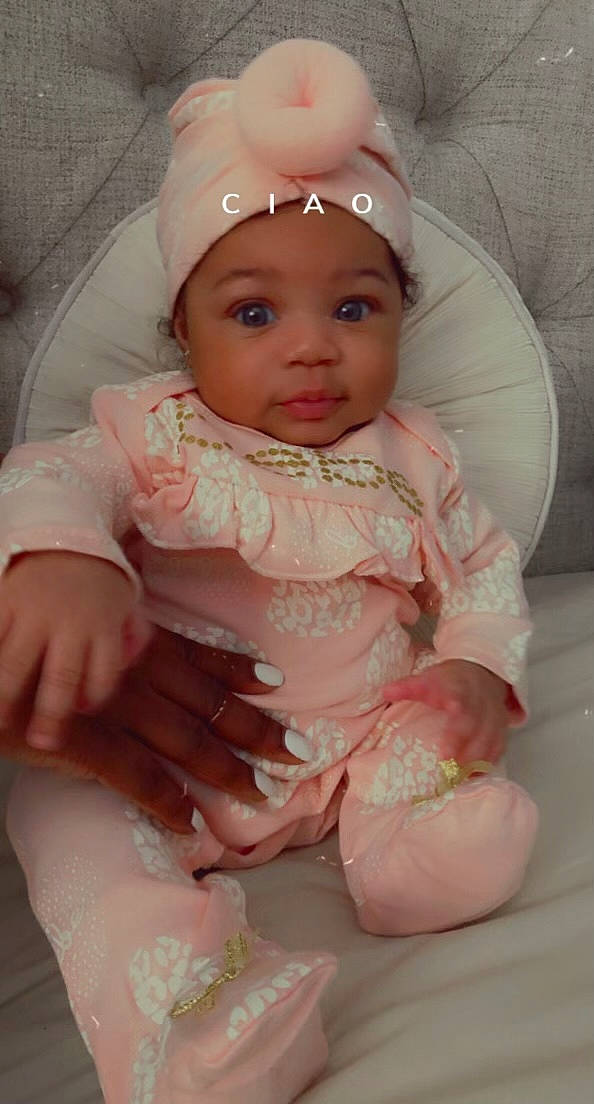 Averi is registered to the contest to win money with this photo: baby, baby_toddler_clothing, cap, cheek, dress, eye, eyebrow, face, finger, head, headband, headpiece, headwear, human_body, iris, lip, person, pink, skin, sleeve