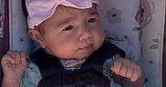 Kaylani joined the competition — help win amazing prizes! baby, infant, car_seat, pink_bow, headband, blanket, floral_pattern, clothing, cute, child, small_hands, face, portrait, sitting, indoors, safety_harness, young_child, expression, soft_light, close_up