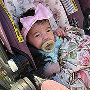 Kaylani is registered to the contest to win money with this photo: baby, baby_girl, blanket, car_seat, child, clothing, cute, face, floral_pattern, headband, indoors, infant, newborn, pacifier, person, pink_bow, portrait, resting, seatbelt, soft_light