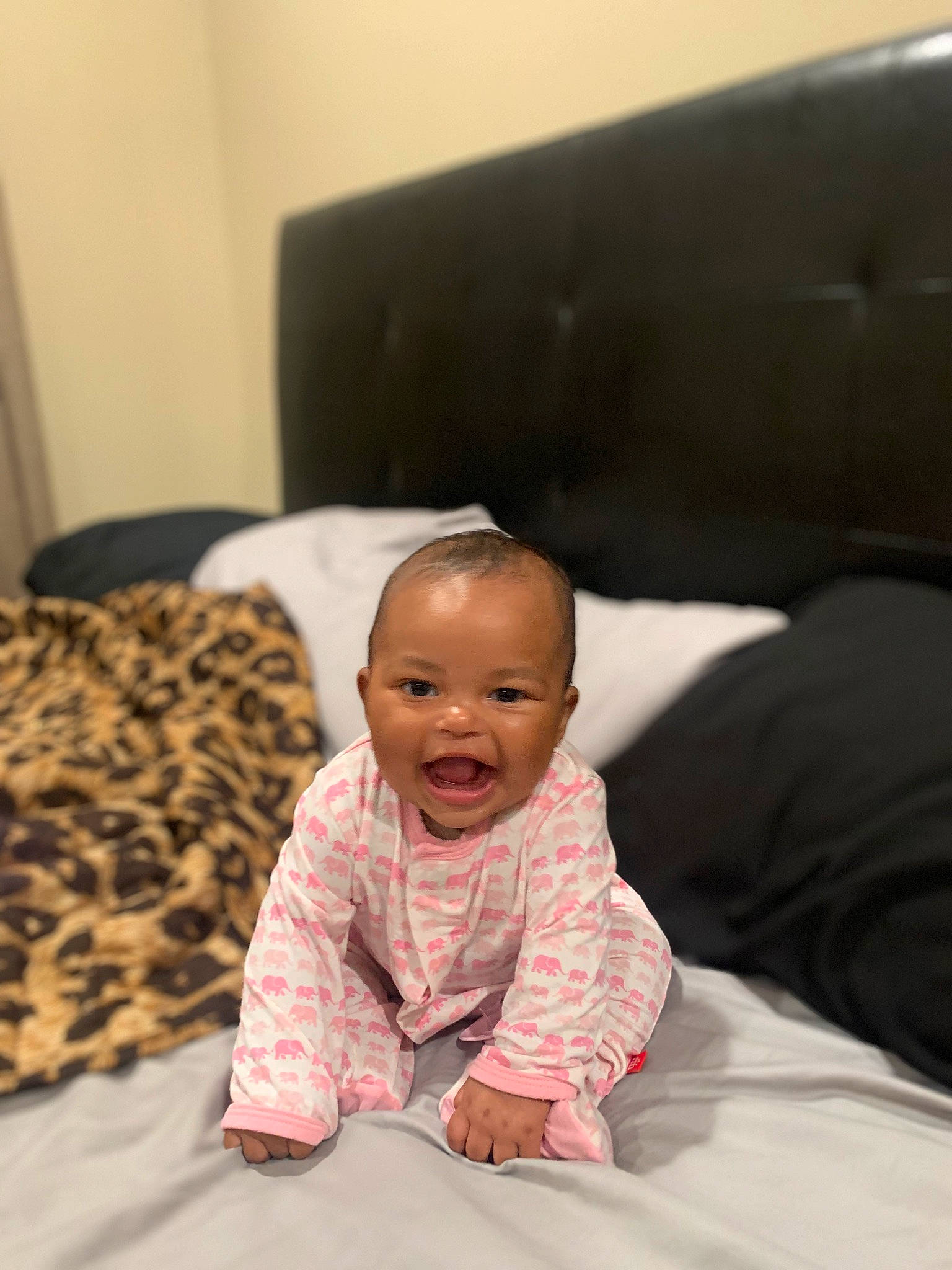 Jenna is registered to the contest to win money with this photo: baby, baby_toddler_clothing, bedding, cheek, comfort, couch, crawling, eye, floor, flooring, fun, happy, hardwood, linens, mammal, person, room, sleeve, smile, toddler