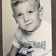 Imran a rejoint le concours — aidez-le/la à gagner de superbes lots ! black_and_white, boy, casual_clothing, child, curious_expression, cute, disney, eyes, face, kid, mickey_mouse, monochrome, photograph, portrait, short_hair, sitting, smile, studio_photo, tshirt, young