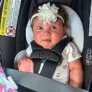 Aurora joined the competition — help win amazing prizes! baby, car_seat, headband, flower, child, infant, seatbelt, blanket, clothing, cute, indoors, portrait, sitting, straps, safety, happy, face, person, closeup, infancy