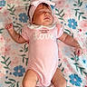 Aurora is registered to the contest to win money with this photo: baby, sleeping, pink_onesie, headband, blanket, floral_pattern, infant, peaceful, cute, child, soft, adorable, lying_down, small, closed_eyes, toddler, indoors, candid, portrait, relaxed