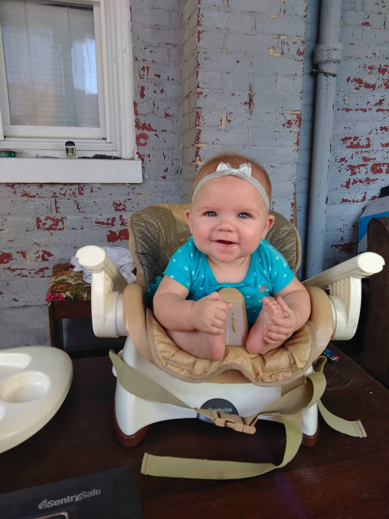 Sienna is registered to the contest to win money with this photo: baby, child, daughter, hand, person, room, sitting, tableware, toddler, vacation