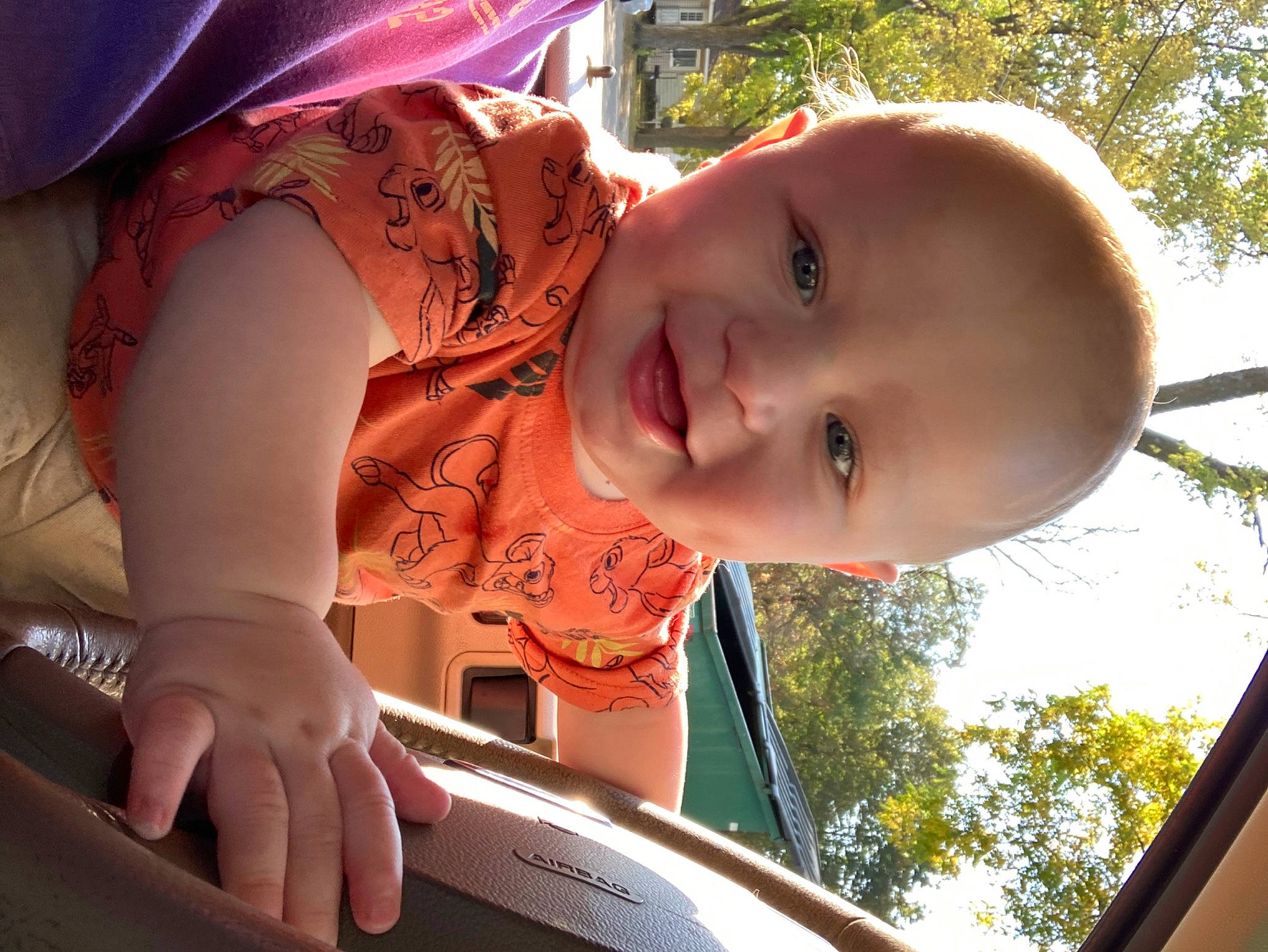 David is registered to the contest to win money with this photo: baby, child, facial_expression, fun, grass, happy, hat, human_body, leisure, mouth, organ, person, pink, recreation, skin, smile, sunlight, toddler, tree, vehicle_door