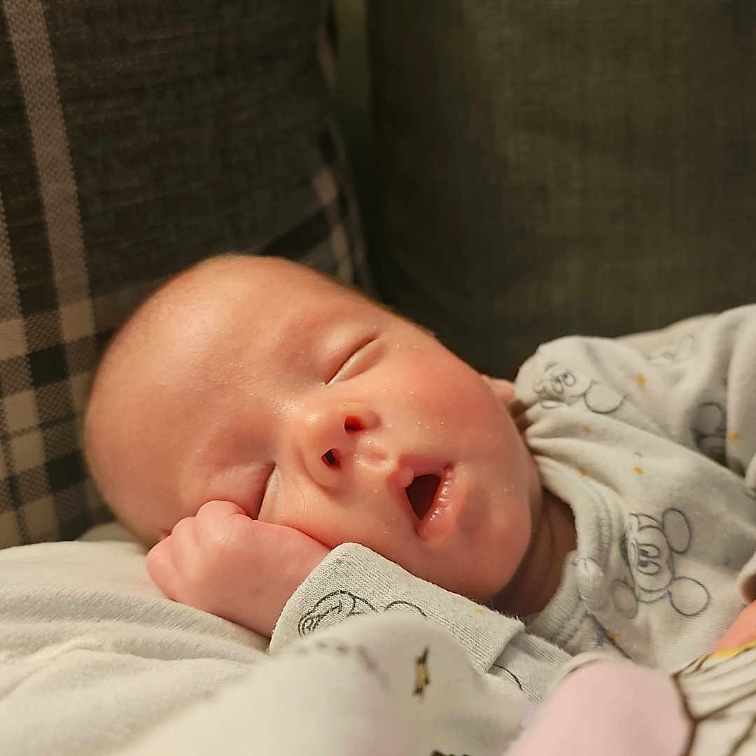 Rohan is registered to the contest to win money with this photo: baby, blanket, cartoon, child, comfort, couch, cozy, cute, face, hand, indoors, infant, pajamas, pattern, peaceful, pillow, relaxation, resting, sleeping, soft