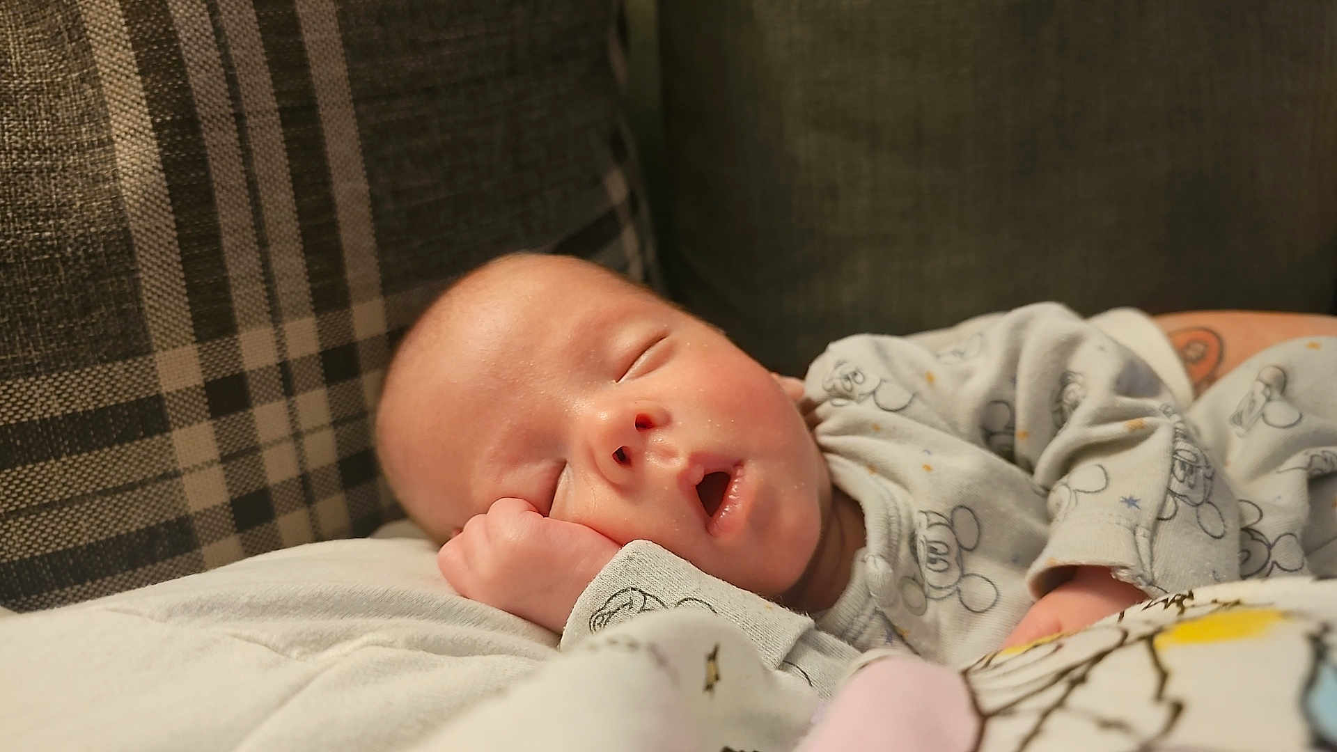 Rohan is registered to the contest to win money with this photo: baby, sleeping, pajamas, hand, face, cozy, blanket, pillow, couch, infant, peaceful, resting, cute, child, indoors, soft, comfort, pattern, cartoon, relaxation
