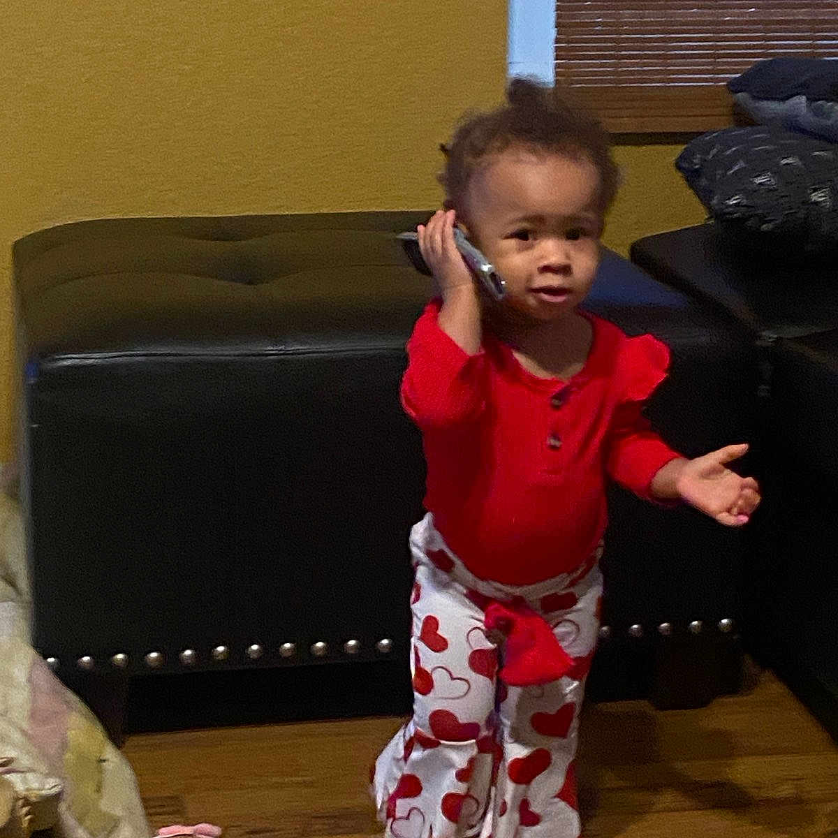Devyn joined the competition — help win amazing prizes! architecture, baby, building, clothing, couch, cushion, electronics, face, furniture, head, indoors, livingroom, mobilephone, pants, person, phone, photography, portrait, room, sitting