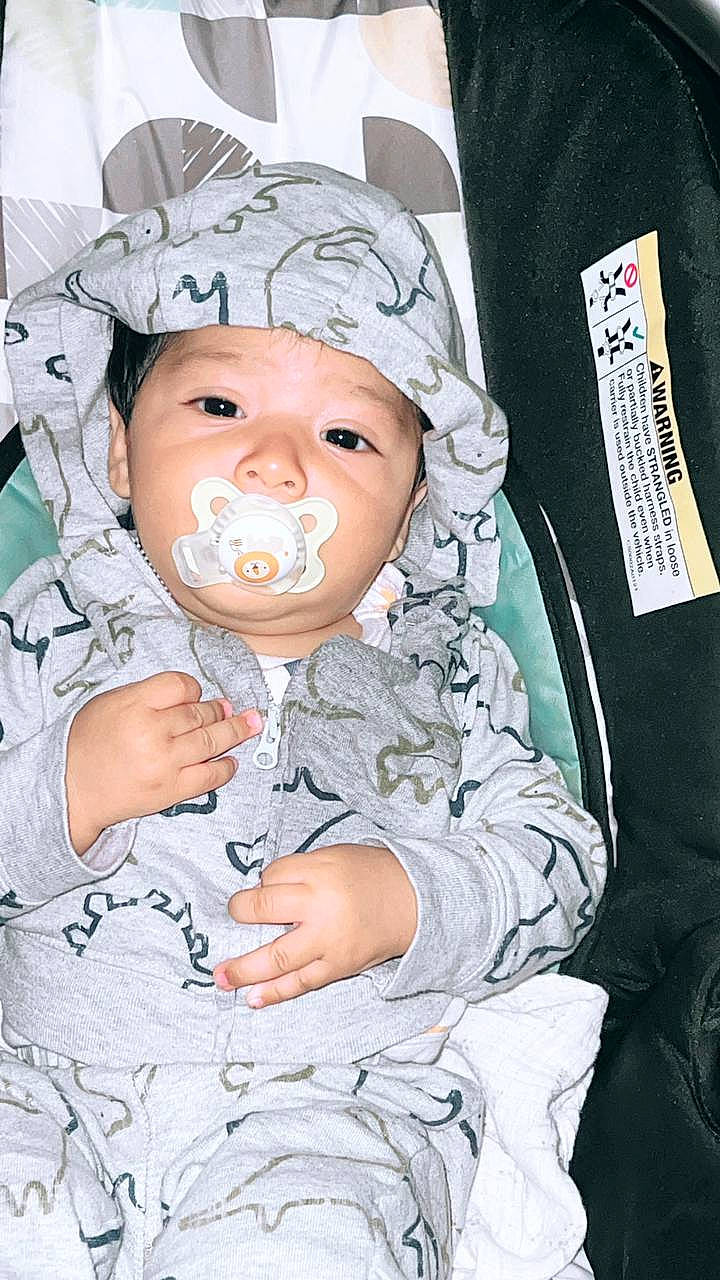 Jesus is registered to the contest to win money with this photo: baby, baby_products, baby_safety, baby_toddler_clothing, cap, cheek, child, comfort, event, eyelash, fashion_accessory, fun, happy, hat, headwear, person, sitting, sleeve, toddler