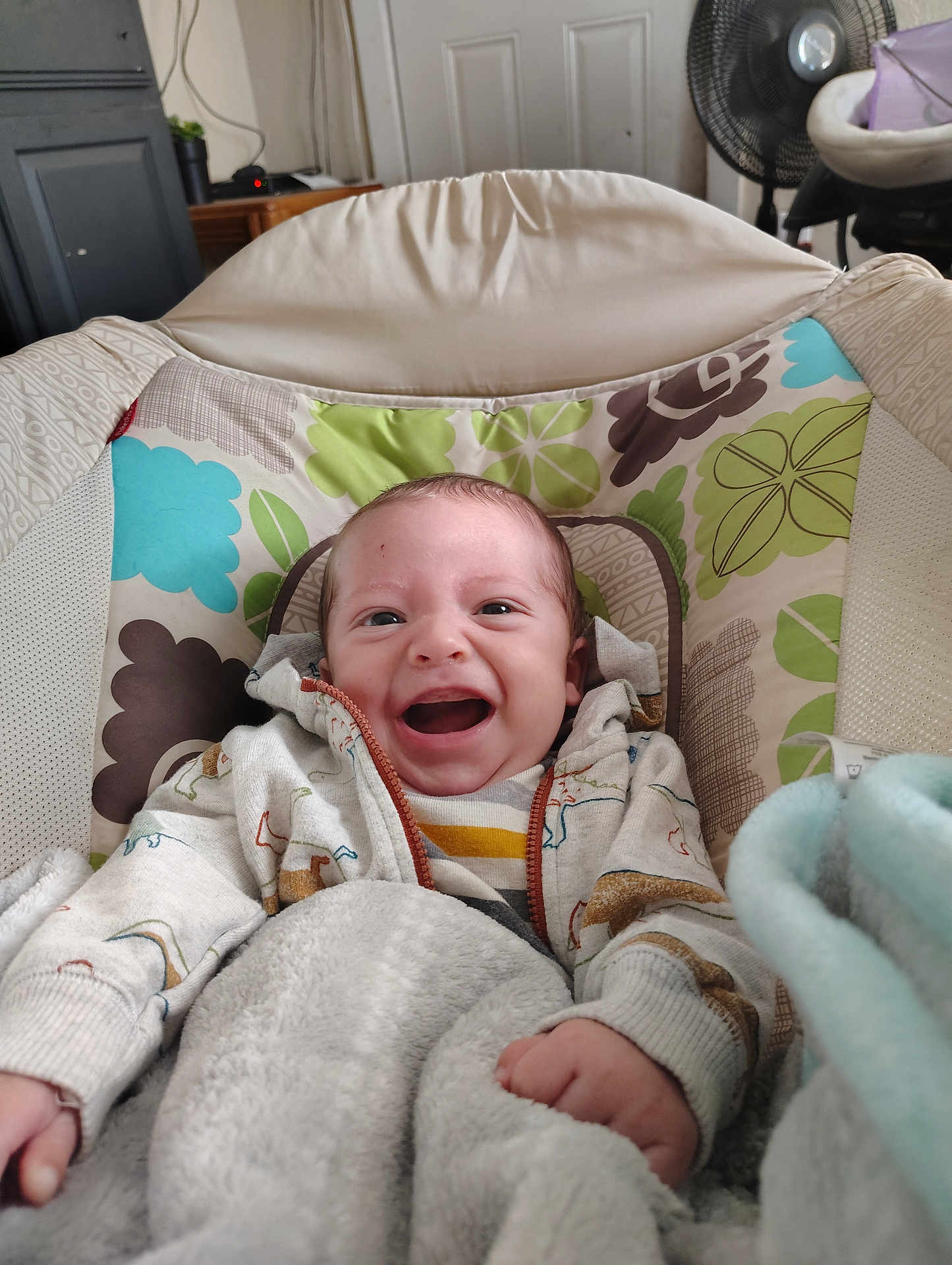Kash joined the competition — help win amazing prizes! baby, smile, hoodie, blanket, infant, indoor, cushion, seat, happy, child, person, pattern, clothing, face, hand, fabric, comfort, cute, young, relaxation