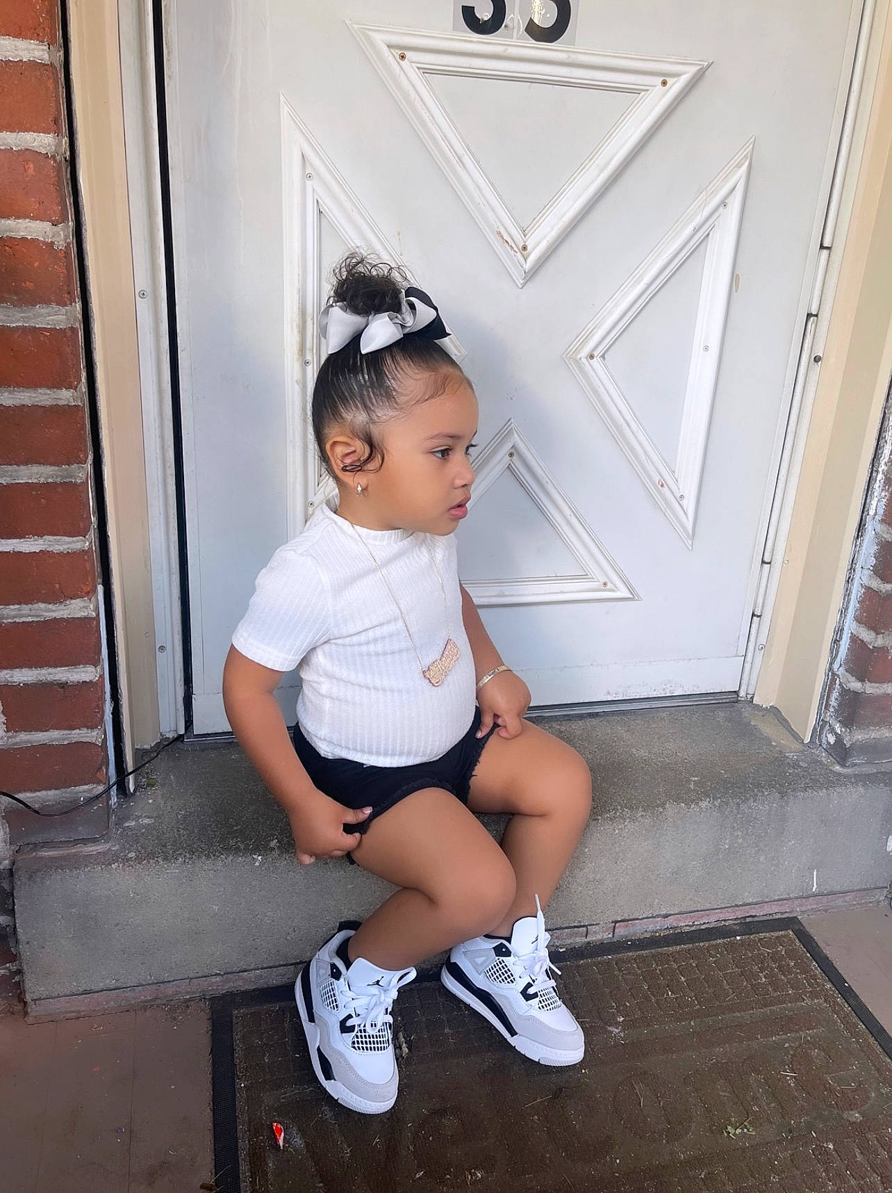 Avianni Celine is registered to the contest to win money with this photo: baby_toddler_clothing, black_hair, cool, door, eye, eyewear, flash_photography, hair, happy, knee, leg, person, shoe, shorts, shoulder, standing, t_shirt, thigh, toddler, trunk