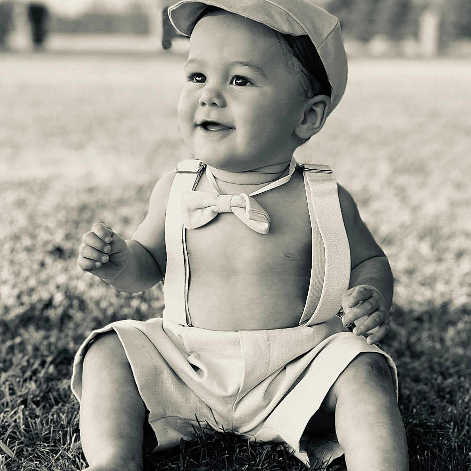 Banksy joined the competition — help win amazing prizes! baby, baseballcap, cap, clothing, dress, face, grass, happy, hat, head, lawn, outdoors, person, photography, plant, portrait, shorts, sitting, smile, summer