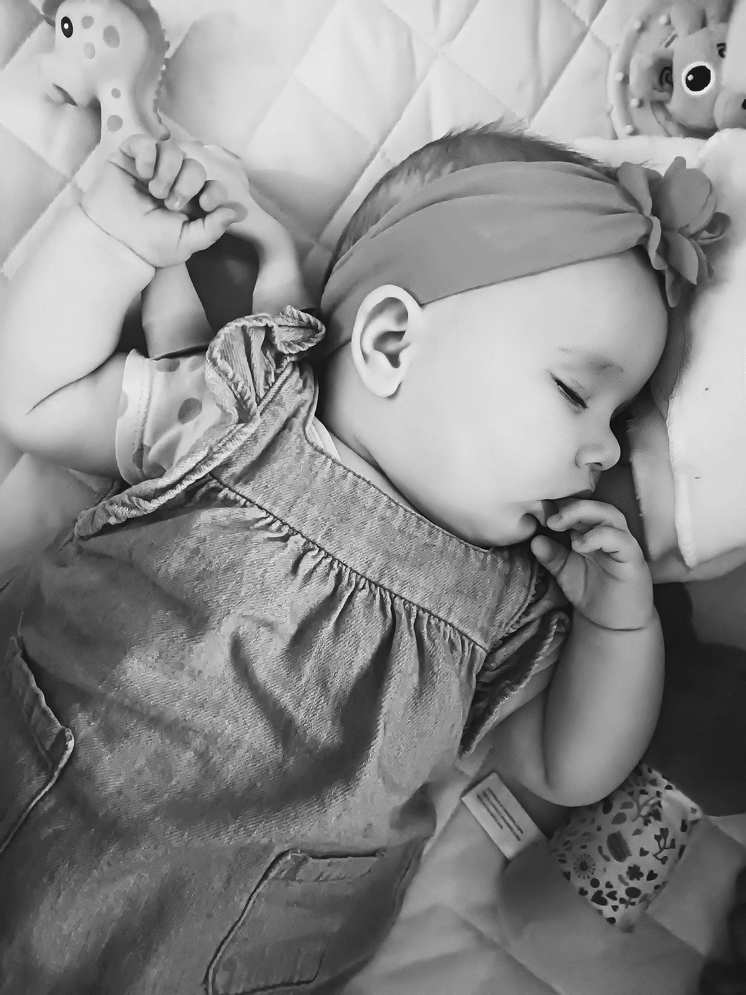 Riley is registered to the contest to win money with this photo: arm, baby, baby_toddler_clothing, black_and_white, cheek, comfort, eye, eyelash, finger, flash_photography, gesture, hand, happy, head, iris, monochrome, person, skin, style, toddler