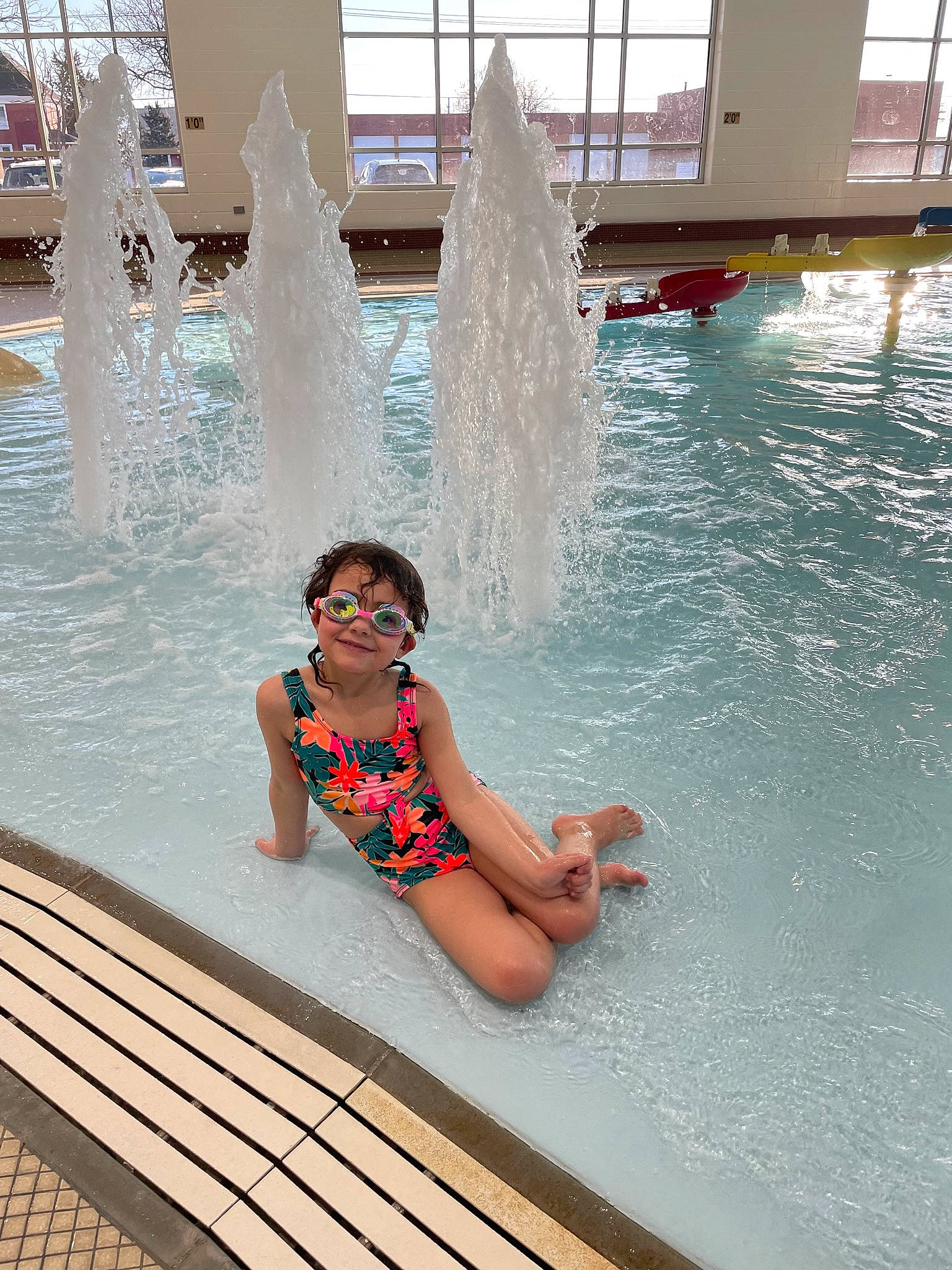 Aria is registered to the contest to win money with this photo: amusement_park, aqua, azure, chute, composite_material, fun, happy, joy, leisure, leisure_centre, nonbuilding_structure, person, recreation, smile, summer, swimming_pool, swimwear, thigh, toddler, vacation