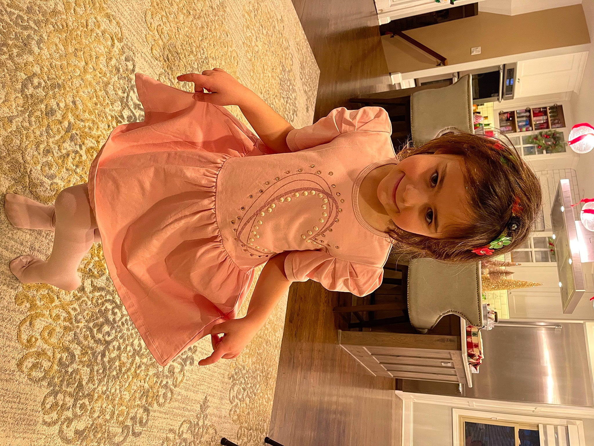 Aria is registered to the contest to win money with this photo: child, countertop, dress, fashion_design, flooring, fun, happy, human_leg, joy, kitchen, kitchen_appliance, magenta, peach, person, refrigerator, sandal, smile, stairs, thigh, toddler