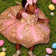 Mckenzie is registered to the contest to win money with this photo: baby, infant, dress, pink, gold, bow, headband, grass, greenery, easter_eggs, colorful, daisies, flower, pacifier, footwear, shoes, cute, portrait, lying_down, celebration