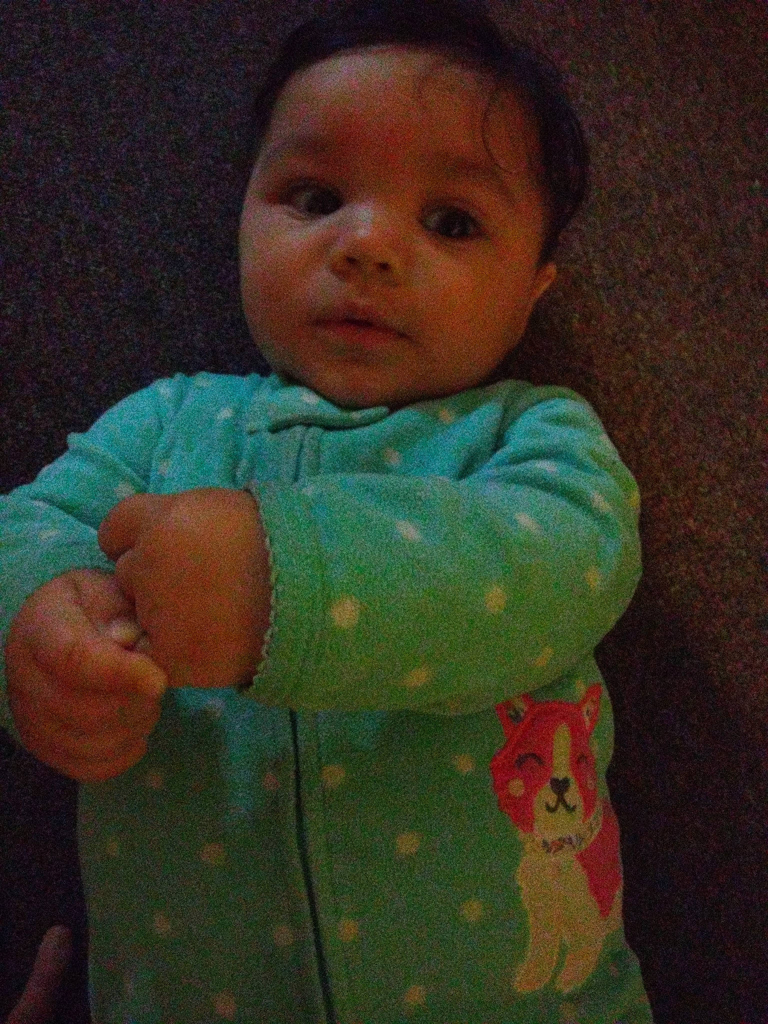 Mia is registered to the contest to win money with this photo: arm, baby, baby_products, baby_toddler_clothing, cheek, child, comfort, elbow, finger, gesture, linens, mouth, nose, pattern, person, skin, sleeve, t_shirt, textile, thumb