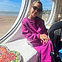 Elena participe au concours pour gagner de l'argent avec cette photo : beach, casual_clothing, child, cozy, girl, hands_folded, heart_pattern, indoor, mosaic_table, natural_light, portrait, purple_outfit, relaxing, sea, seaside, seated, sky, sunglasses, sunlight, window
