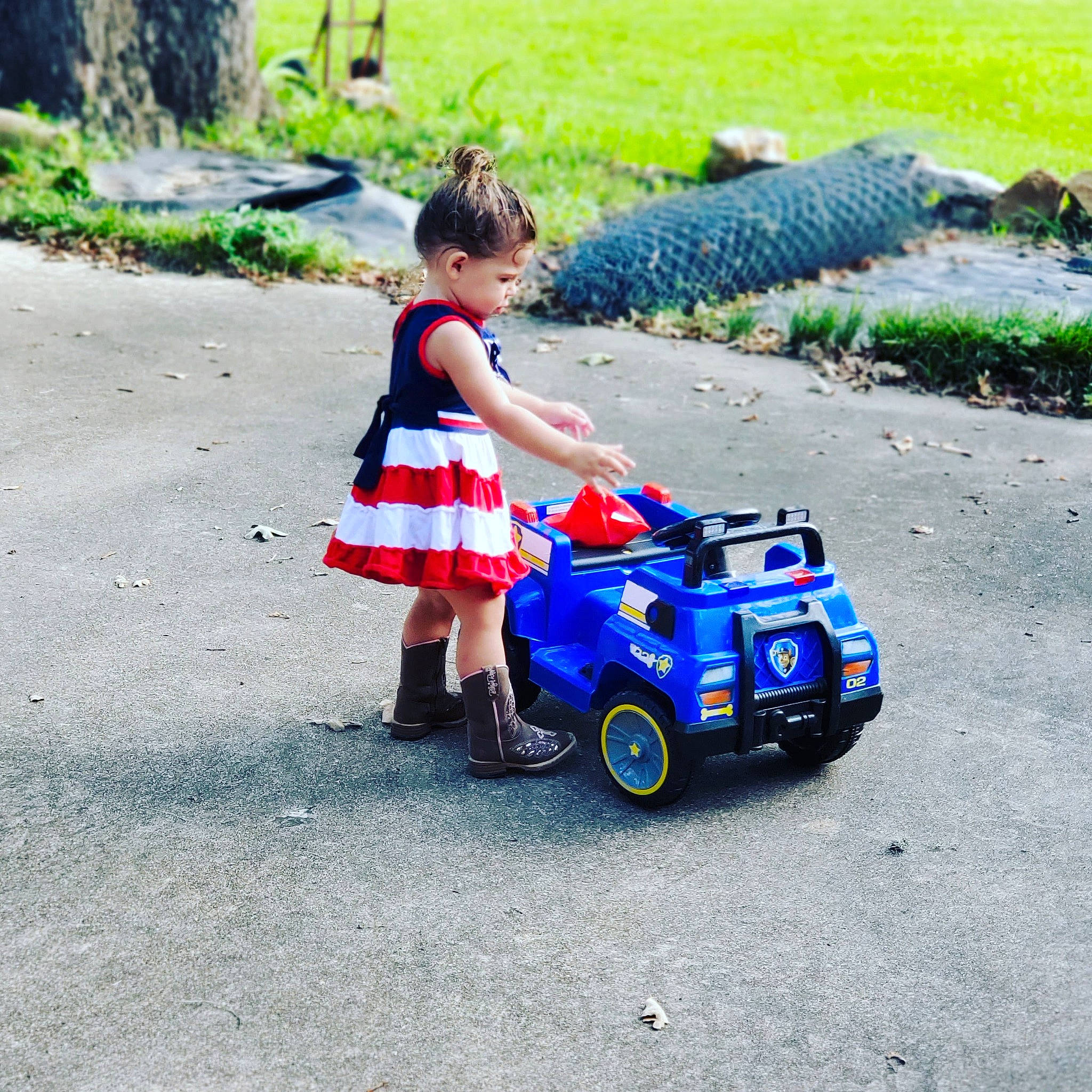 Peighton is registered to the contest to win money with this photo: asphalt, car, child, city_car, compact_car, electric_blue, family_car, grass, person, plant, play, riding_toy, summer, toddler, travel, vacation, vehicle