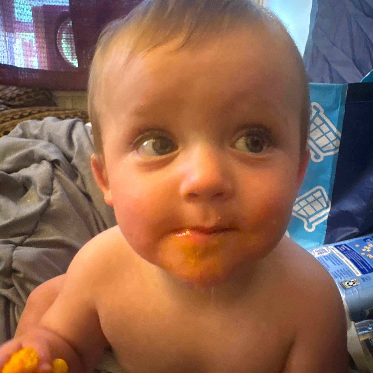 Maurisio is registered to the contest to win money with this photo: bare_chest, blanket, box, child, curious, curtain, expression, face, food, hand, home, indoor, messy, person, plastic_bag, portrait, snack, toddler, window, young_child