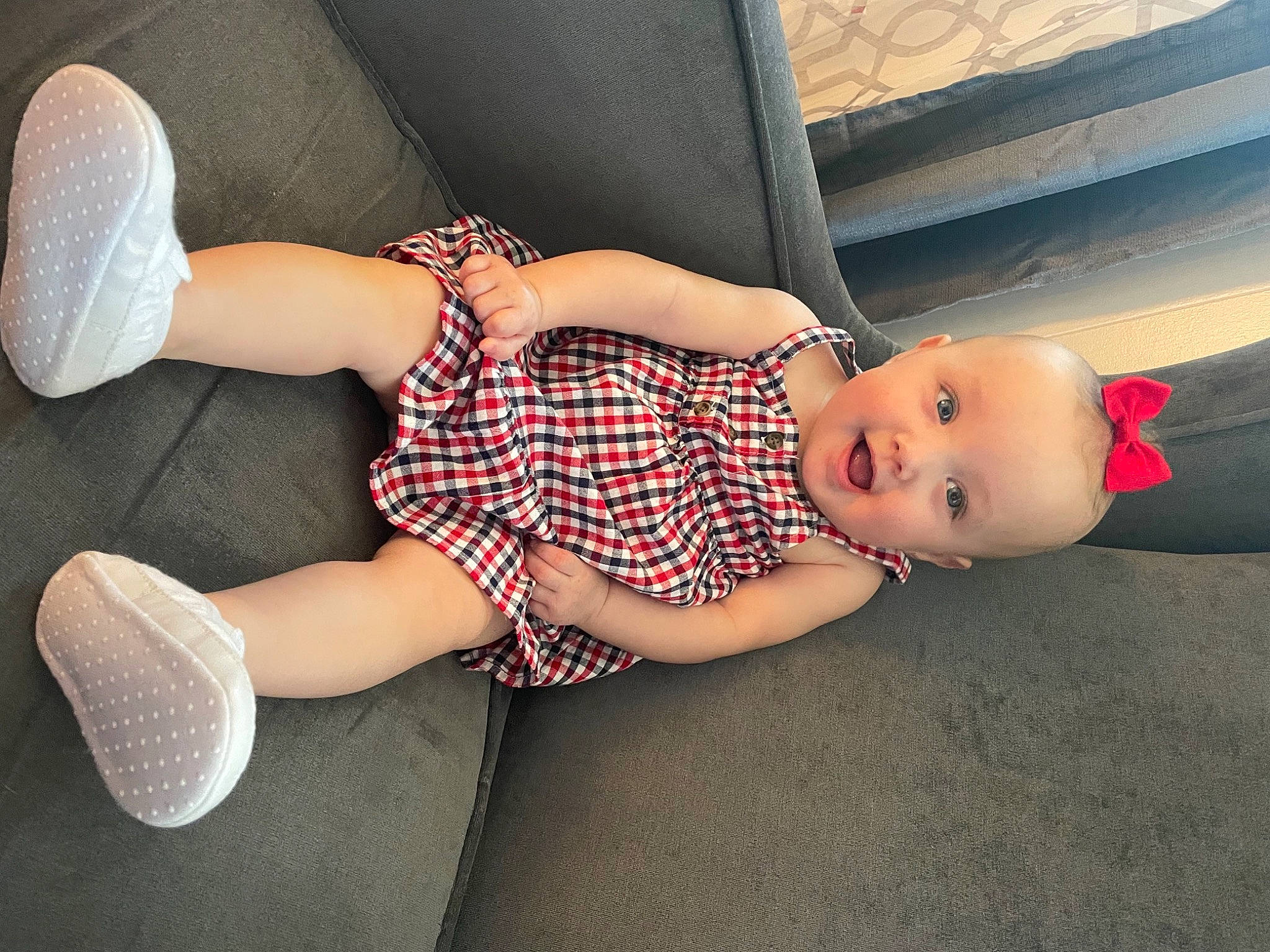 Isabella is registered to the contest to win money with this photo: baby_toddler_clothing, calf, comfort, dress, elbow, finger, flooring, foot, human_body, human_leg, joint, knee, lap, pattern, person, sock, thigh, toddler, toy, trunk