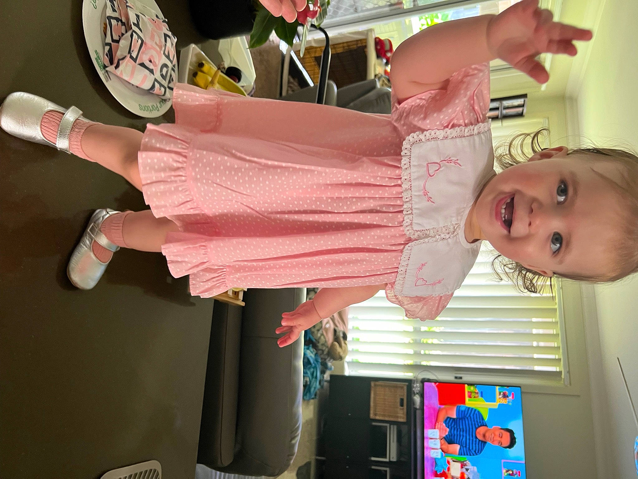 Charli is registered to the contest to win money with this photo: arm, baby, baby_products, baby_toddler_clothing, child, event, fashion_design, fun, happy, head, human_leg, joy, magenta, party, peach, person, pink, room, smile, textile