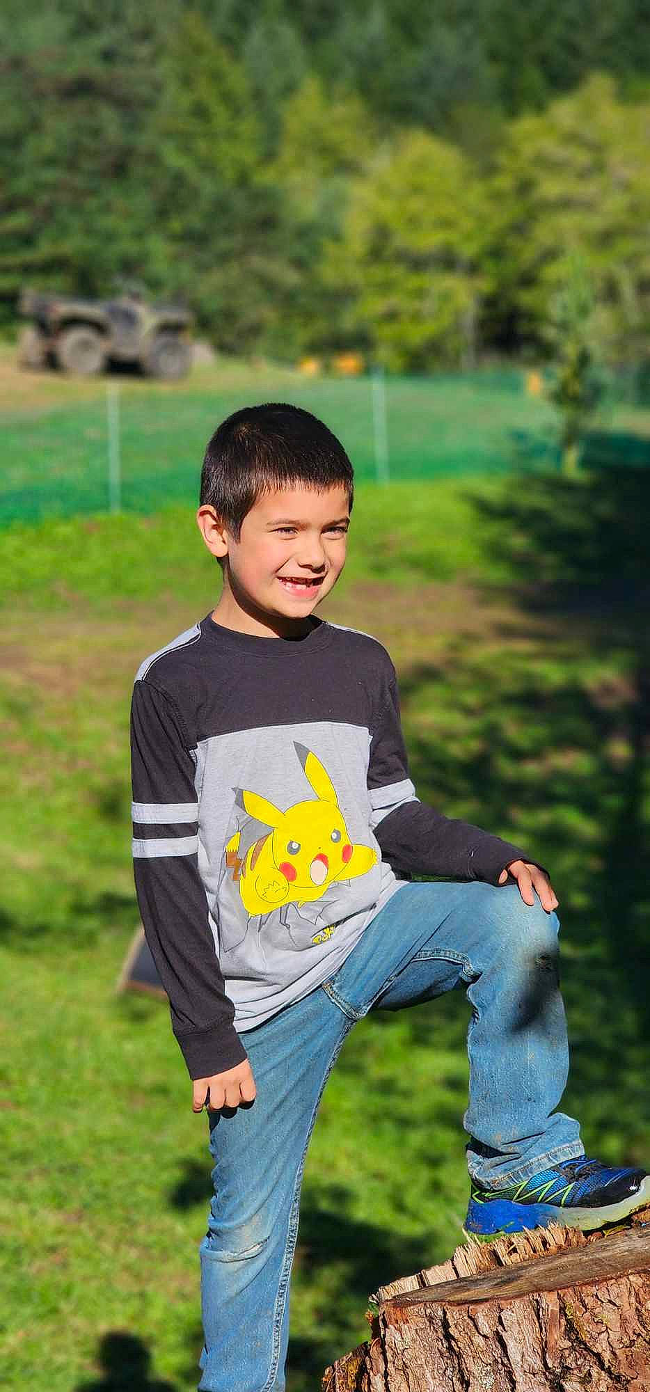 Azrael is registered to the contest to win money with this photo: child, denim, flash_photography, fun, grass, grassland, happy, jeans, joy, lawn, leisure, people, person, plant, recreation, sitting, sleeve, smile, spring, summer