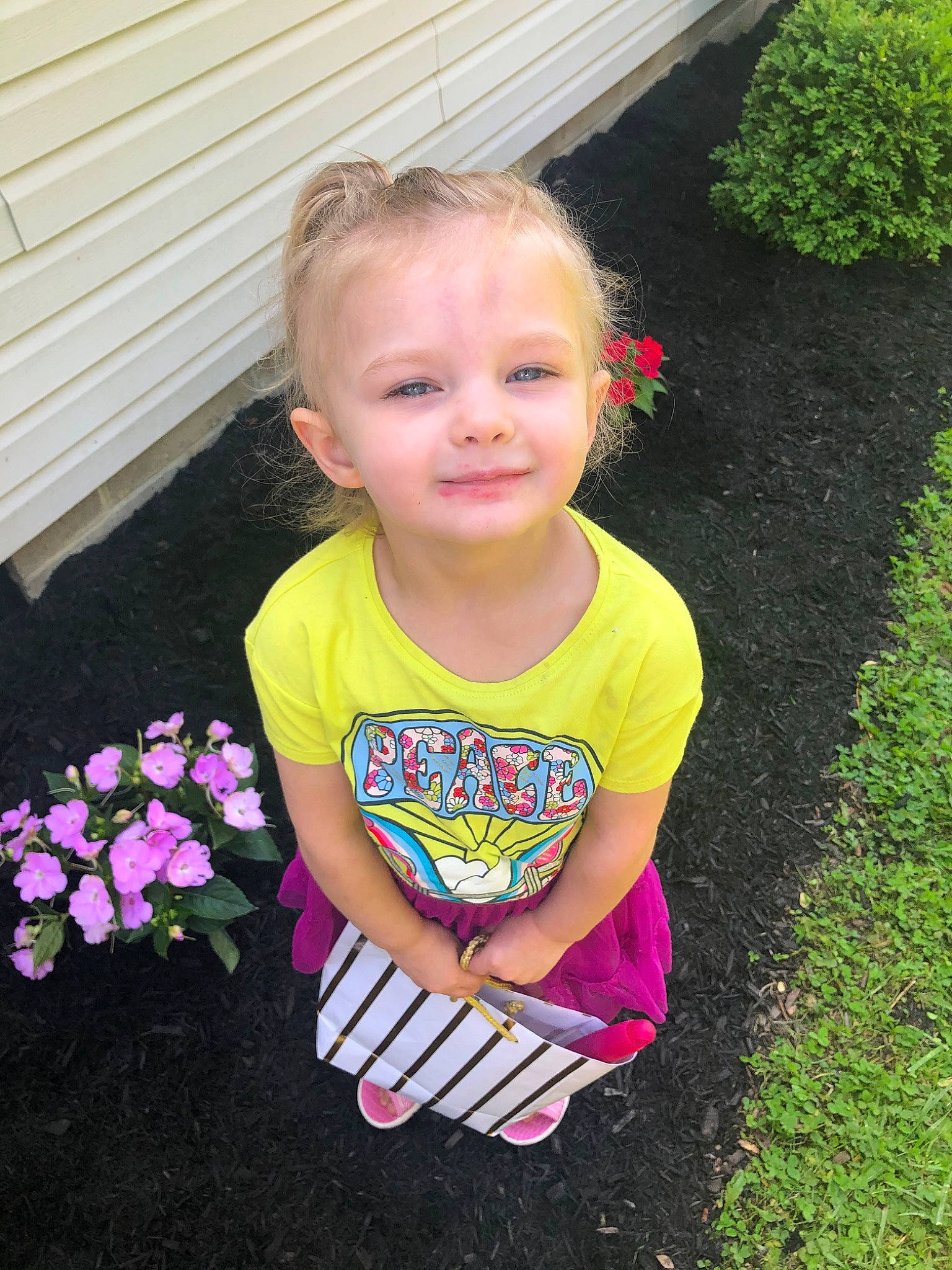 Mary is registered to the contest to win money with this photo: baby_toddler_clothing, child, face, flower, fun, garden, grass, happy, joy, lawn, leaf, magenta, people_in_nature, person, petal, pink, plant, sleeve, smile, summer