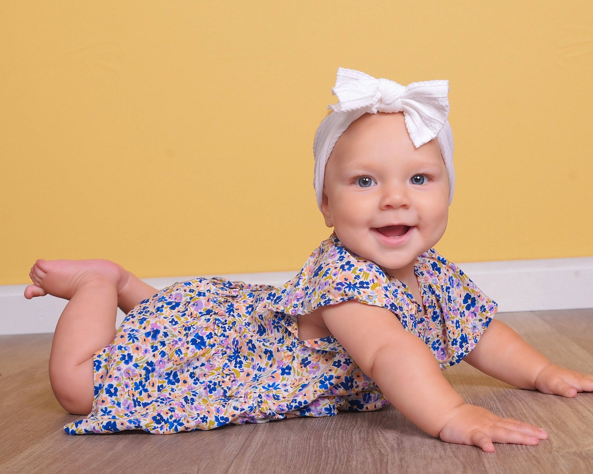 Sienna joined the competition — help win amazing prizes! baby, baby_toddler_clothing, barefoot, child, electric_blue, face, fashion_accessory, flooring, foot, hair_accessory, happy, head, headgear, headwear, human_body, human_leg, joy, pattern, person, sitting