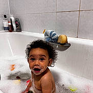 Reign joined the competition — help win amazing prizes! toddler, bath, bubble, soap, water, toy, curly_hair, child, bathtub, bathroom, foam, happy, playful, skin, face, person, cleaning, sitting, indoor, cute
