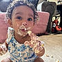 Reign is registered to the contest to win money with this photo: toddler, child, messy_face, cream, cake, curly_hair, blue_outfit, sitting, indoors, living_room, floor, curious_expression, baby, food, hand, playful, cute, portrait, home, smudge