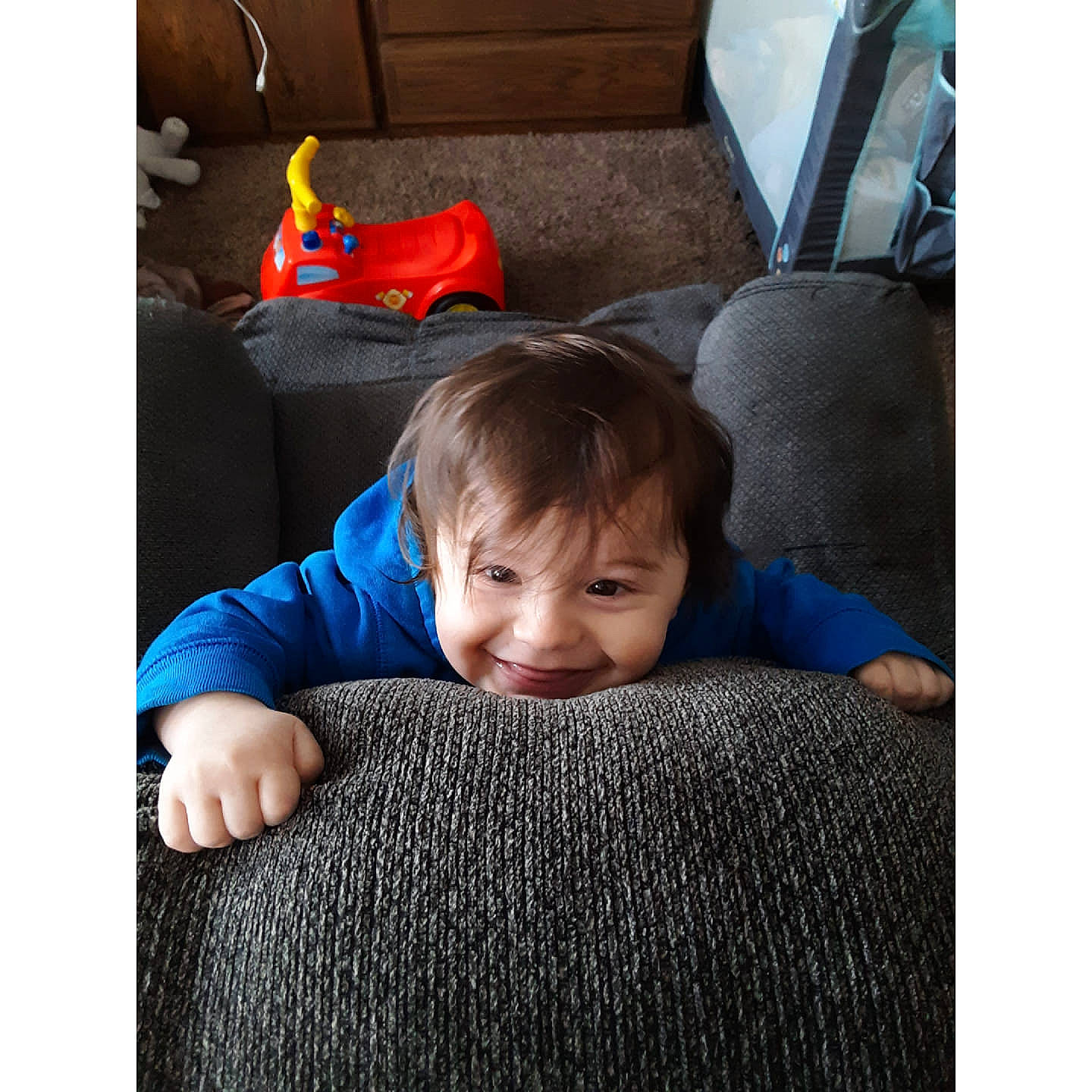 Boston is registered to the contest to win money with this photo: baby, blue, carpet, child, comfort, couch, crawling, floor, flooring, furniture, joy, person, play, product, sitting, smile, snapshot, square, toddler, tummy_time