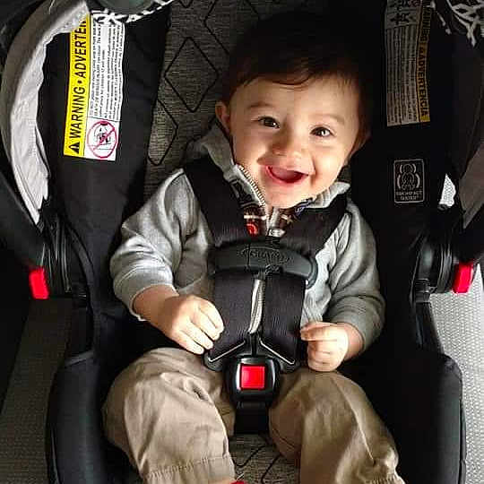 Boston is registered to the contest to win money with this photo: auto_part, baby, baby_carriage, baby_in_car_seat, baby_products, car_seat, child, helmet, joy, motorcycle_helmet, person, personal_protective_equipment, photography, product, seat_belt, toddler