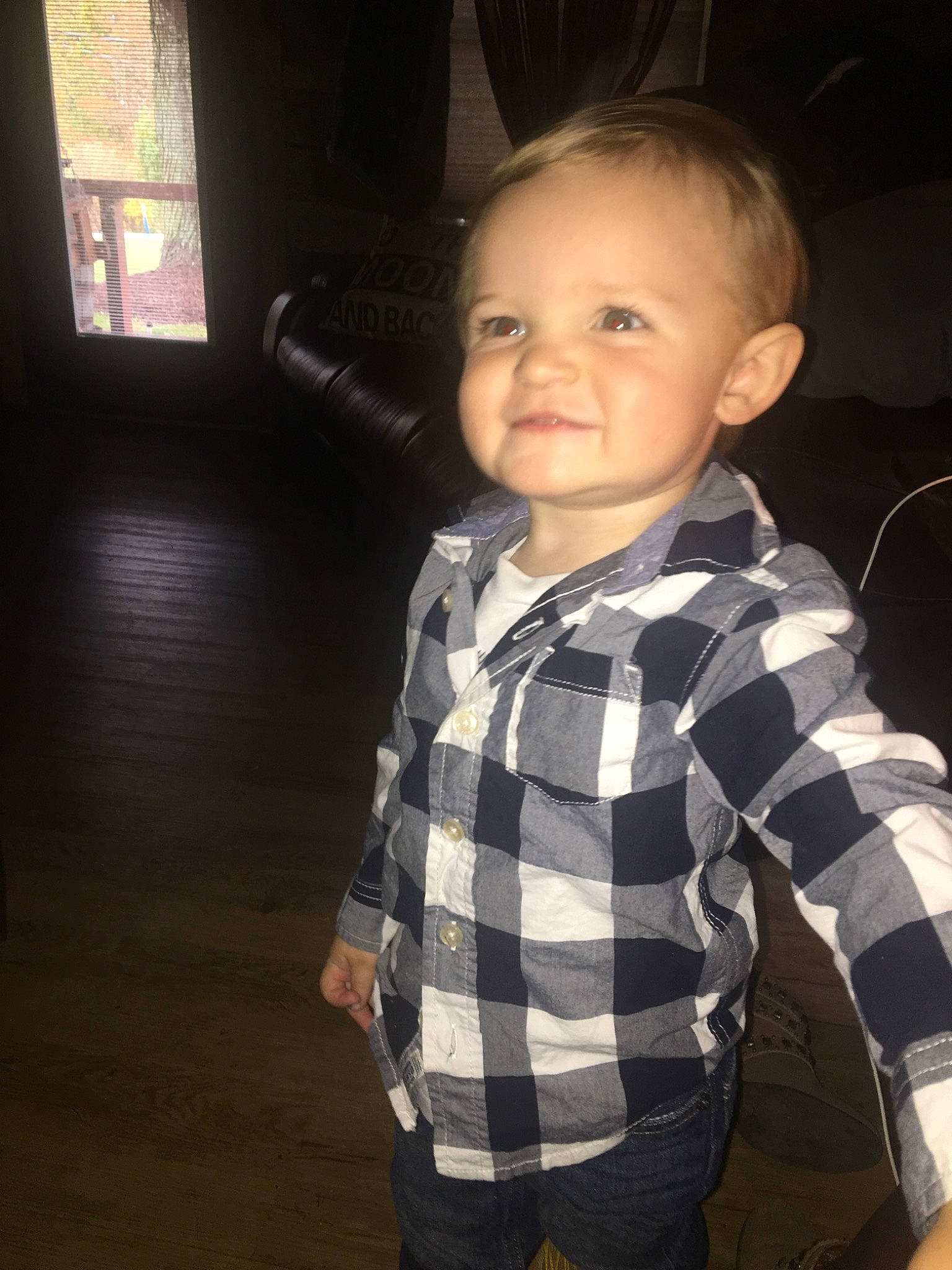 Wyatt is registered to the contest to win money with this photo: baby, cheek, child, electronic_device, face, fun, head, outerwear, pattern, person, skin, smile, standing, t_shirt, toddler, vacation