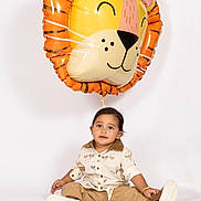 Jodhveer joined the competition — help win amazing prizes! toddler, child, balloon, lion_balloon, studio, white_background, casual_clothing, sitting, footwear, smiling, cute, playful, indoor, portrait, person, young_child, fashion, toy, celebration, happy