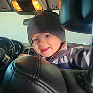 Grayson Rhett is registered to the contest to win money with this photo: baby, cap, clothing, coat, cushion, face, glove, happy, hat, head, headrest, homedecor, jacket, person, photography, portrait, selfie, smile, transportation, vehicle