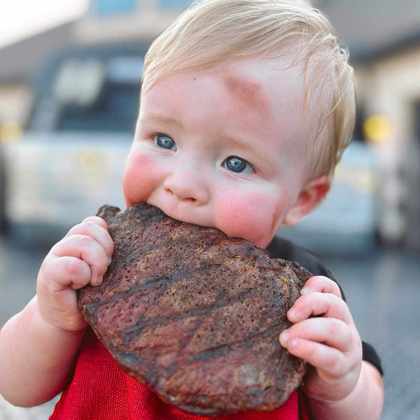 Grayson Rhett is registered to the contest to win money with this photo: baby, beef, biting, bodypart, city, clothing, coat, eating, face, finger, food, hand, head, jacket, meat, person, photography, portrait, ribs, sweets