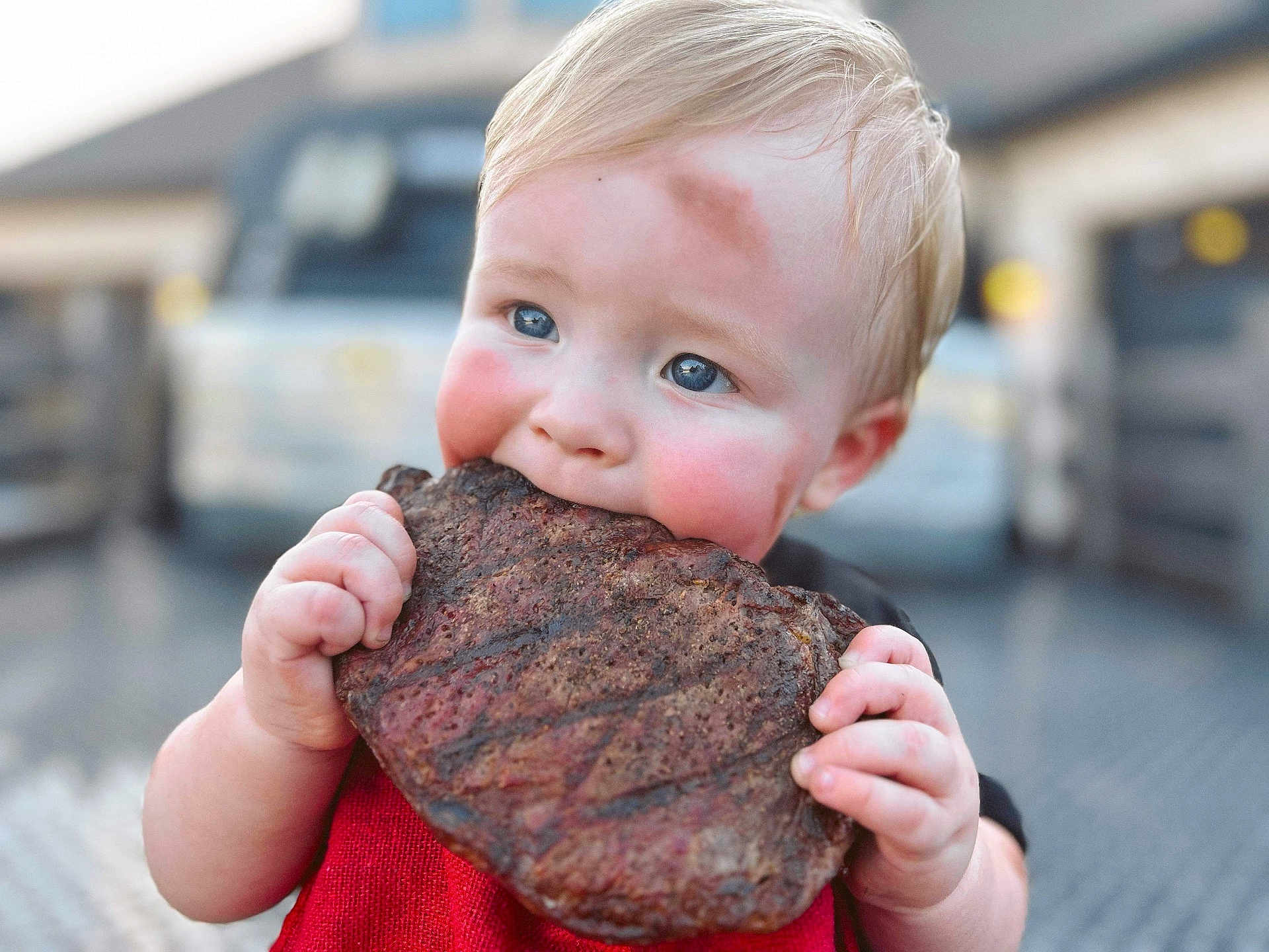 Grayson Rhett is registered to the contest to win money with this photo: baby, beef, biting, bodypart, city, clothing, coat, eating, face, finger, food, hand, head, jacket, meat, person, photography, portrait, ribs, sweets
