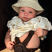 Kayson is registered to the contest to win money with this photo: baby, infant, hat, blanket, car_seat, straps, face, skin, hand, clothing, cute, child, portrait, seatbelt, fabric, expression, headwear, comfort, sitting, indoors
