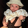 baby, infant, hat, blanket, car_seat, straps, face, skin, hand, clothing, cute, child, portrait, seatbelt, fabric, expression, headwear, comfort, sitting, indoors