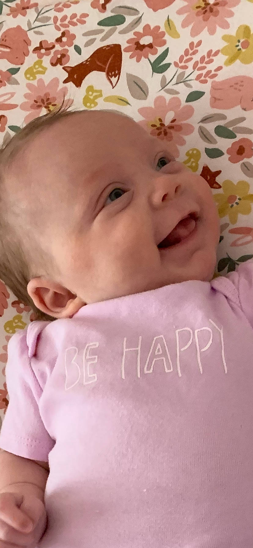 Emmy is registered to the contest to win money with this photo: baby, baby_toddler_clothing, cheek, child, comfort, eyelash, fashion_accessory, happy, linens, lip, magenta, pattern, peach, person, petal, pink, skin, sleeve, smile, textile