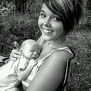 Hunter joined the competition — help win amazing prizes! baby, woman, smile, outdoor, nature, black_and_white, portrait, happy, infant, holding, grass, person, young_adult, face, head, sitting, tender, affection, resting, clothing