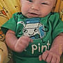 baby, infant, smiling, green_onesie, milk_carton_graphic, yellow_blanket, cartoon_bears, cute, happy, fist, cuddly, child, portrait, indoors, soft_toys, face, head, skin, person, cozy