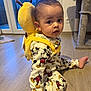 baby, toddler, onesie, mickey_mouse, plush_backpack, yellow_backpack, backpack, wooden_floor, indoor, window, sliding_door, cat_tree, sitting, curious_expression, big_eyes, barefoot, pajamas, home, toy, portrait