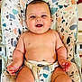 baby, child, smiling, sitting, infant, happy, face, skin, seat, patterned, clothing, indoor, cute, chubby, hands, legs, head, comfort, joyful, young