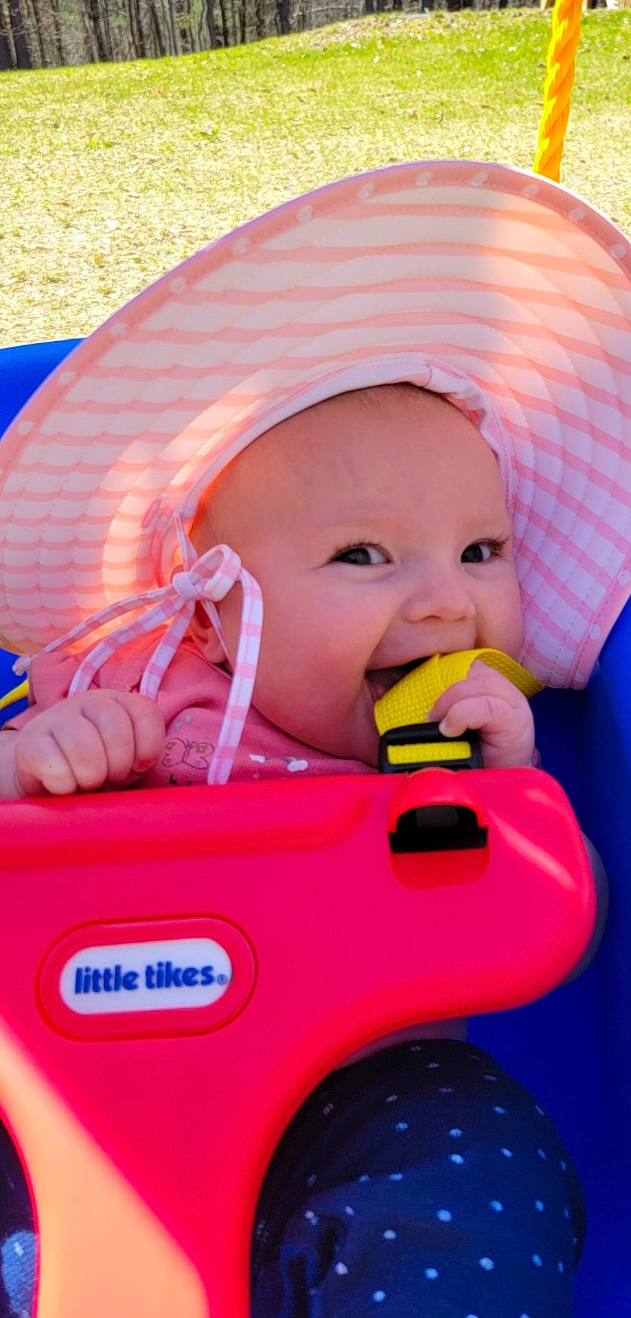 Chloe is registered to the contest to win money with this photo: baby, baby_carriage, baby_playing_with_toys, baby_products, baby_safety, baby_toddler_clothing, blue, child, face, facial_expression, fun, happy, headwear, mouth, nose, orange, person, pink, skin, smile
